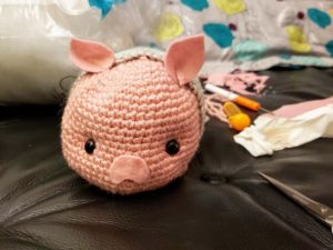 a pink crocheted pig stuffie